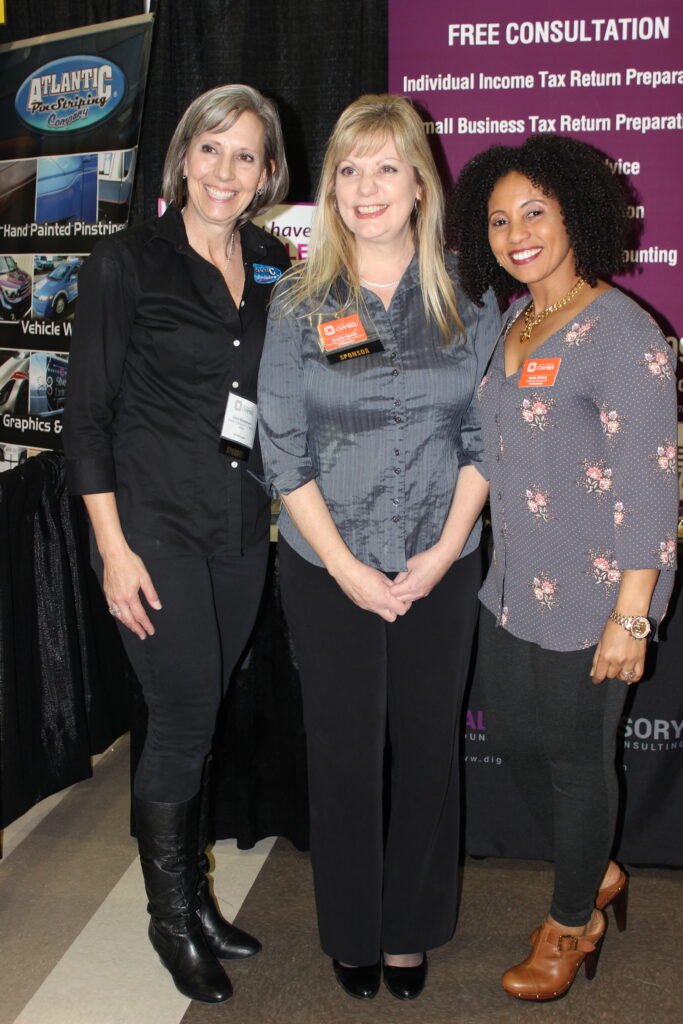 Women in front of a display at a business expo