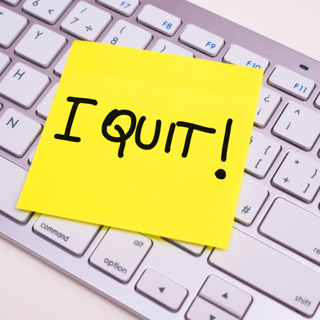 Computer keyboard with post-it on that says "I Quit."