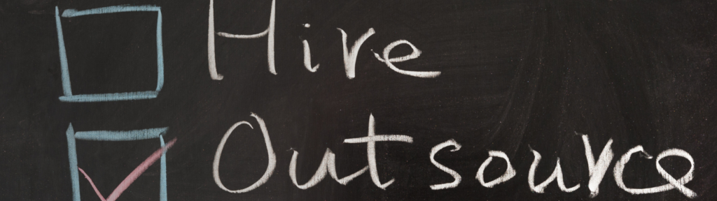 "Hire or Outsource" written on chalkboard