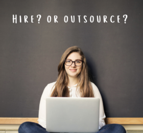 Woman sitting in front of chalkboard that says "Hire or Outsource?"