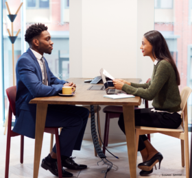 Woman interviewing man for job